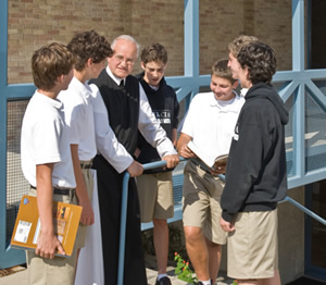 Fr. Bernard chats with students.