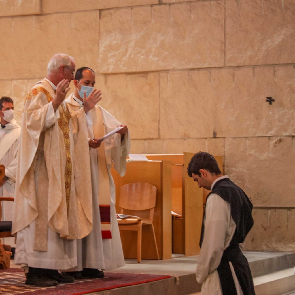 Abbot Peter prays over Father Christopher