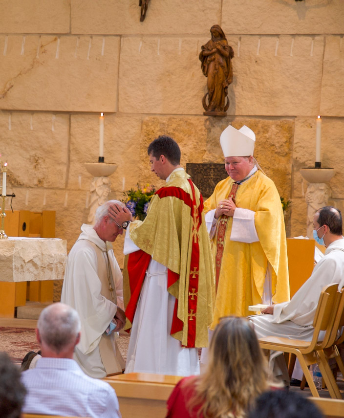 Father Francis blesses Father Peter